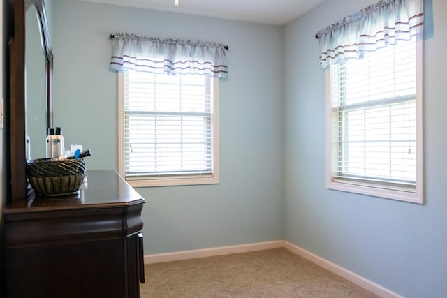 interior space with baseboards and carpet flooring