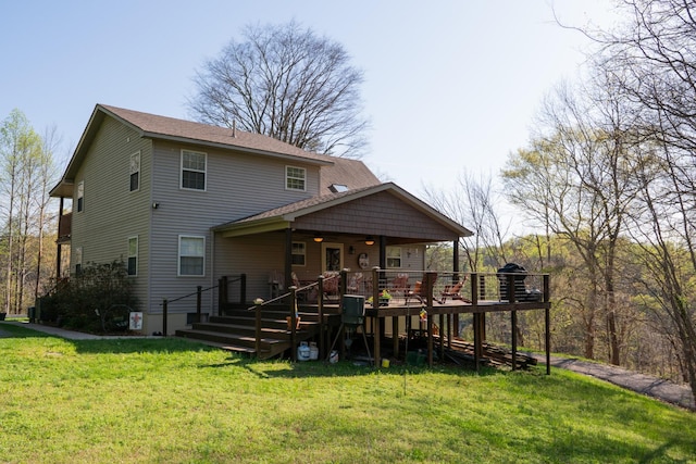 back of property with a wooden deck and a lawn