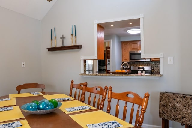 dining area with recessed lighting and vaulted ceiling
