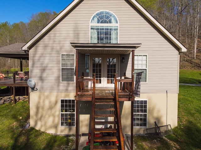back of house featuring french doors, a yard, a deck, and stairs