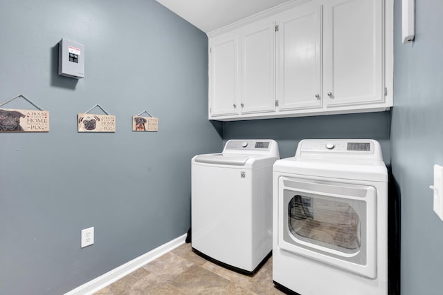 clothes washing area with cabinet space, independent washer and dryer, and baseboards