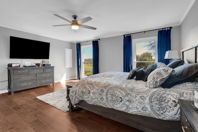 bedroom with a ceiling fan, baseboards, multiple windows, and dark wood-style floors