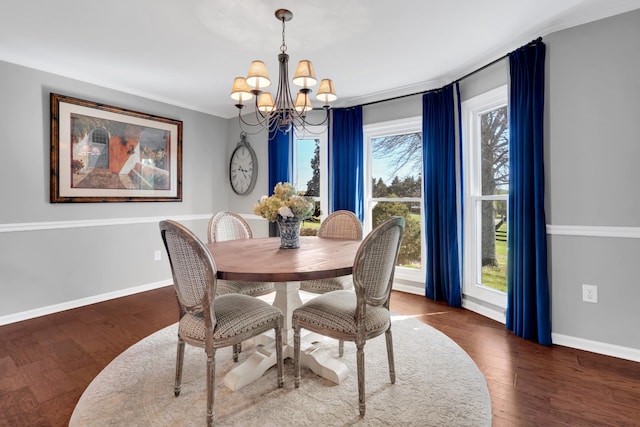 dining area with a notable chandelier, wood finished floors, and a healthy amount of sunlight