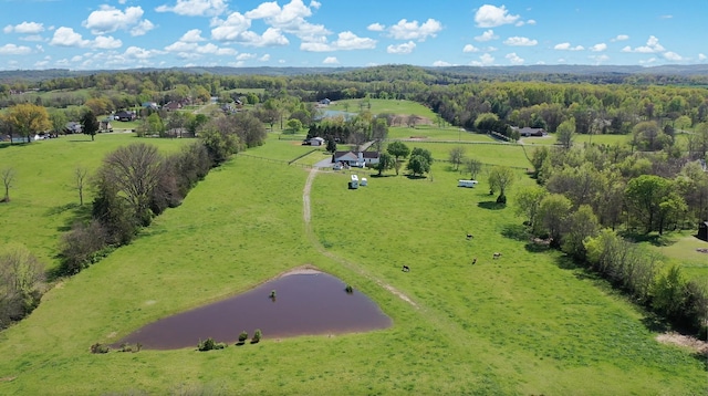 birds eye view of property featuring a water view and a rural view