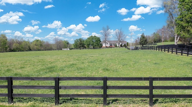 view of yard with a rural view and fence