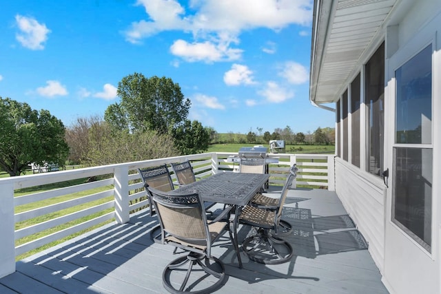 wooden terrace featuring outdoor dining space