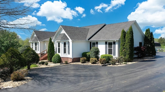 view of side of home featuring a shingled roof