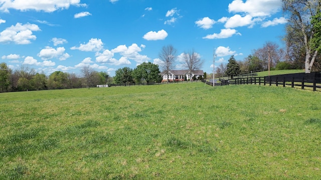 view of yard with a rural view and fence