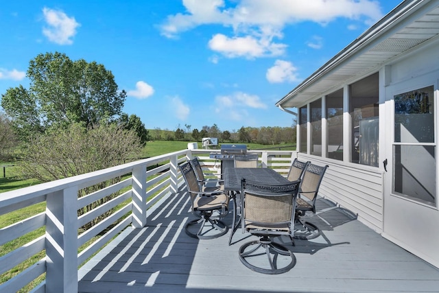 wooden deck with outdoor dining space and a sunroom