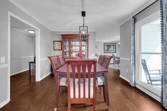 dining area featuring crown molding, baseboards, dark wood finished floors, and visible vents