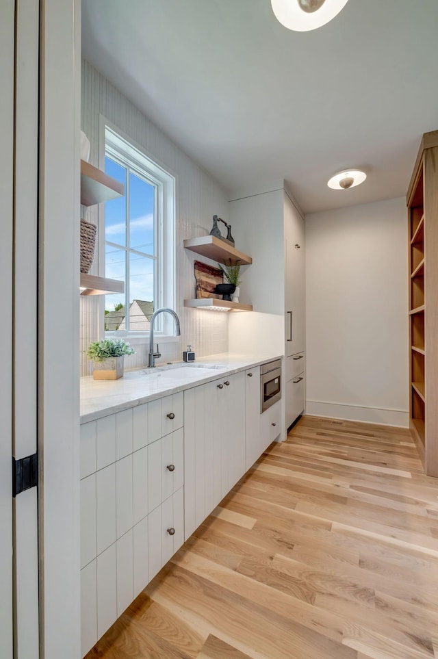 128 Alton Rd, Nashville, TN 37205 - interior space featuring a sink, stainless steel microwave, light wood finished floors, and baseboards