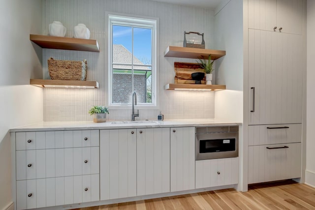 128 Alton Rd, Nashville, TN 37205 - kitchen featuring backsplash, a sink, open shelves, and light wood-style floors