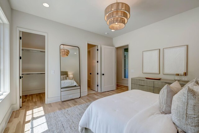 128 Alton Rd, Nashville, TN 37205 - bedroom with wood finished floors, an inviting chandelier, a closet, and a spacious closet