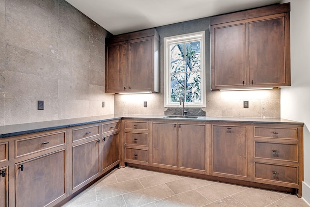 128 Alton Rd, Nashville, TN 37205 - kitchen with tasteful backsplash, light tile patterned floors, a sink, and dark countertops