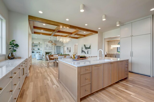 128 Alton Rd, Nashville, TN 37205 - kitchen featuring light brown cabinets, open floor plan, light wood-style floors, beamed ceiling, and a sink