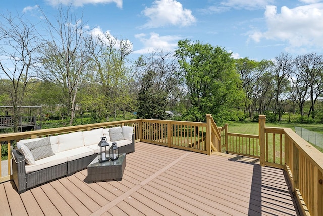 wooden deck with a yard and outdoor lounge area