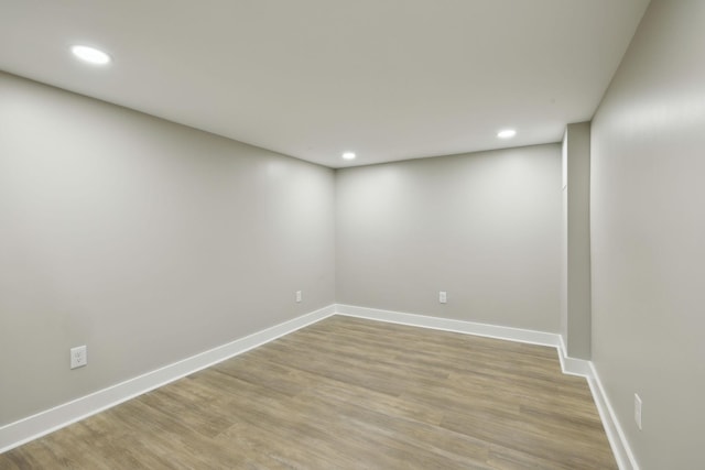 finished below grade area with baseboards, recessed lighting, and light wood finished floors