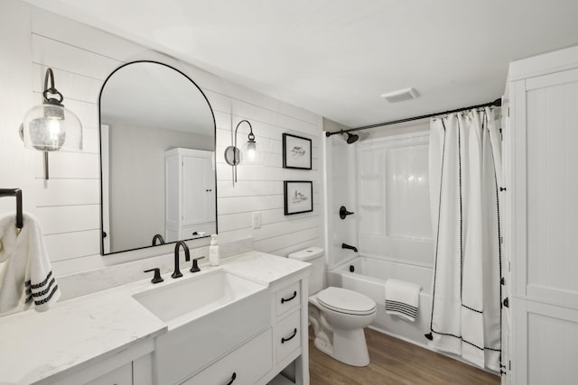 full bath with vanity, visible vents, toilet, shower / bath combo, and wood finished floors