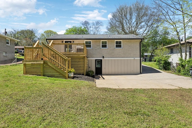 view of front of property with a wooden deck, a front yard, and stairs