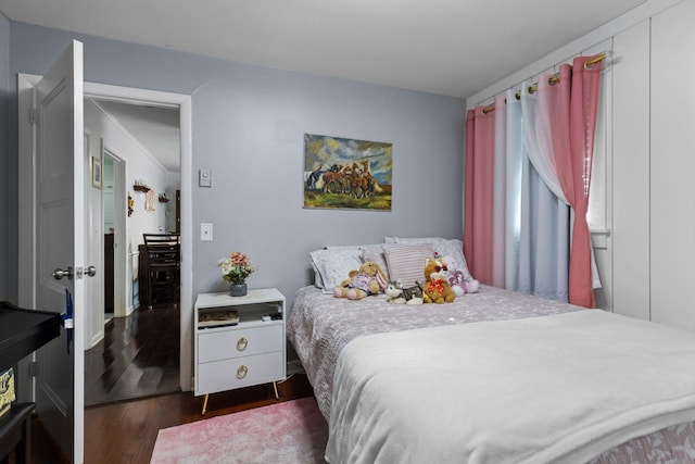 bedroom with dark wood-style floors
