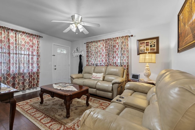 living area featuring a ceiling fan and dark wood finished floors