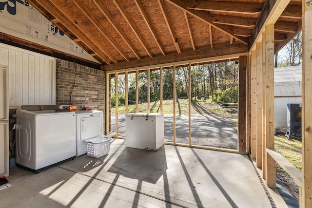 unfurnished sunroom featuring separate washer and dryer