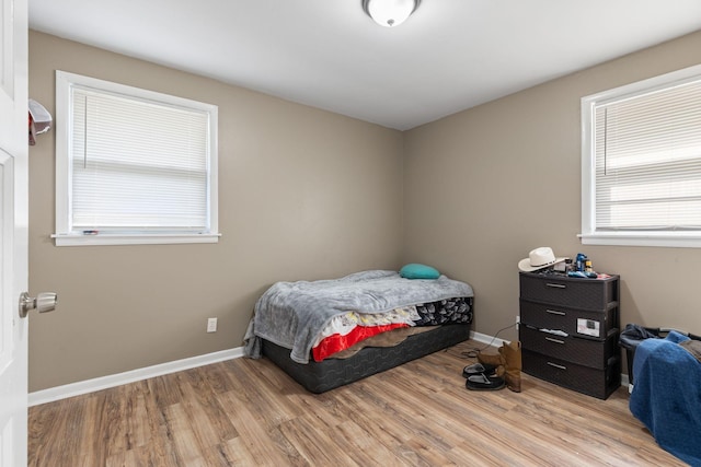 bedroom featuring baseboards and wood finished floors
