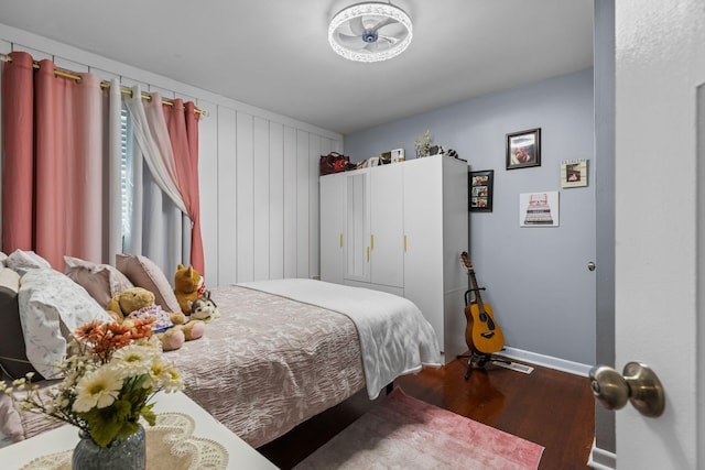 bedroom featuring wood finished floors and baseboards