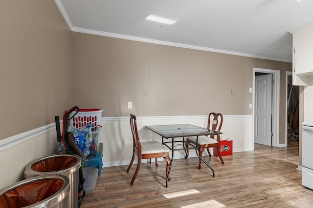 dining area featuring ornamental molding and wood finished floors