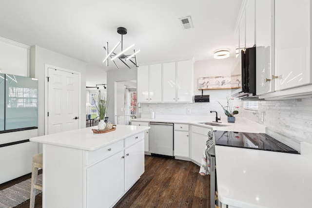 245 Wisteria Dr, Franklin, TN 37064 - kitchen featuring visible vents, a kitchen island, dark wood-style flooring, stainless steel appliances, and backsplash