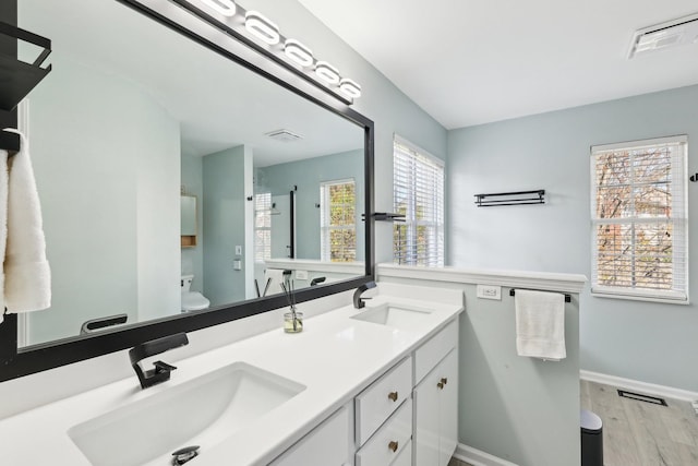 245 Wisteria Dr, Franklin, TN 37064 - bathroom with visible vents, a sink, toilet, and wood finished floors