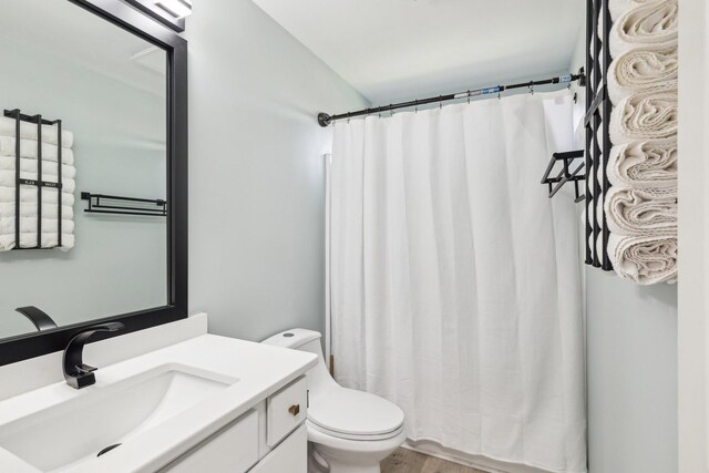 245 Wisteria Dr, Franklin, TN 37064 - bathroom with a shower with shower curtain, vanity, toilet, and wood finished floors