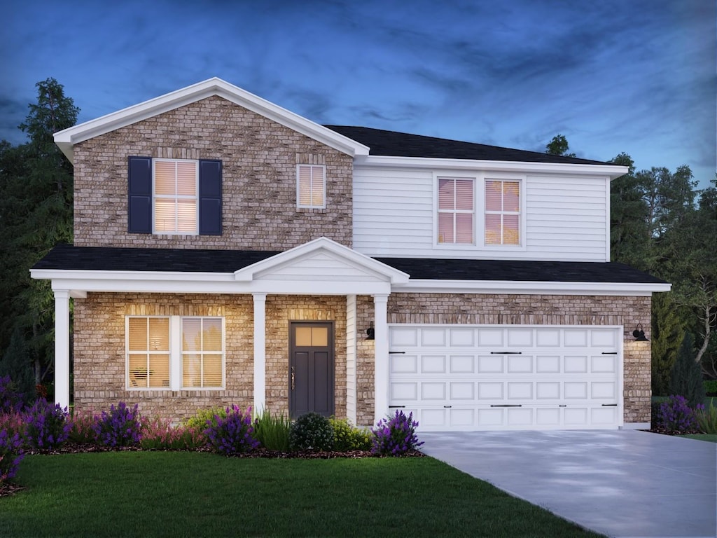 view of front facade with a front yard, a garage, and concrete driveway
