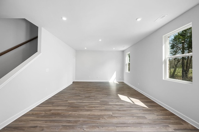 spare room with wood finished floors, baseboards, visible vents, and recessed lighting