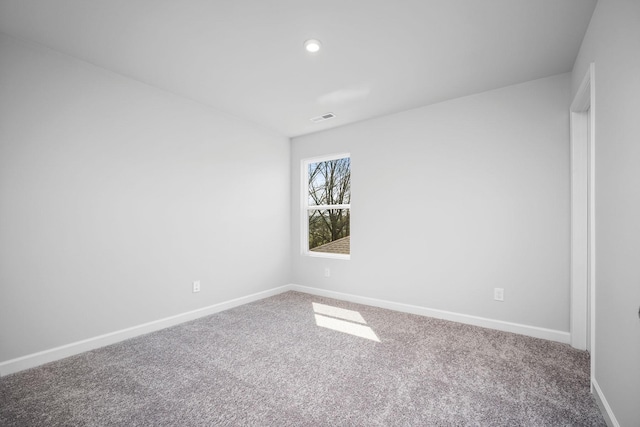carpeted spare room with visible vents, baseboards, and recessed lighting