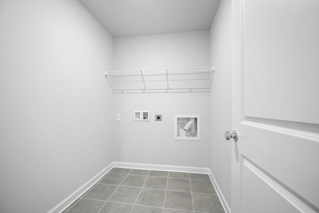 washroom with baseboards, hookup for an electric dryer, hookup for a washing machine, and laundry area