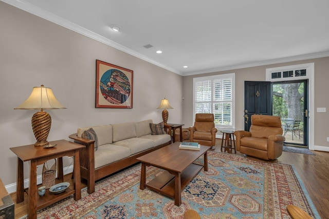 living room with crown molding, baseboards, recessed lighting, and wood finished floors