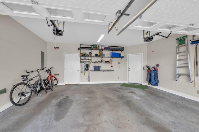 garage with a garage door opener, baseboards, and electric panel