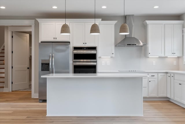 kitchen featuring stainless steel appliances, recessed lighting, and wall chimney exhaust hood