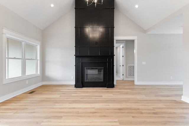 unfurnished living room with baseboards, high vaulted ceiling, a fireplace, and visible vents