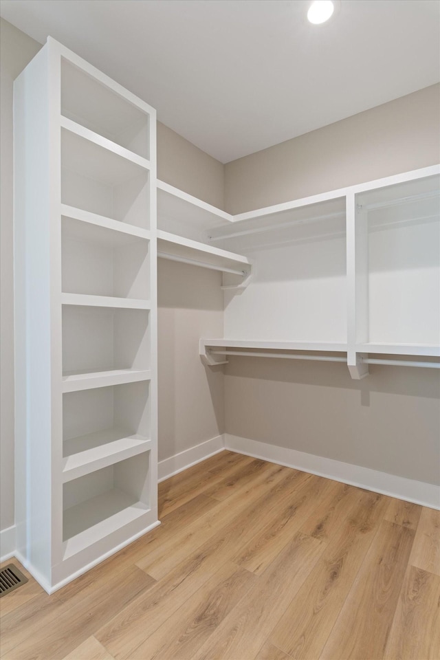 spacious closet with wood finished floors and visible vents