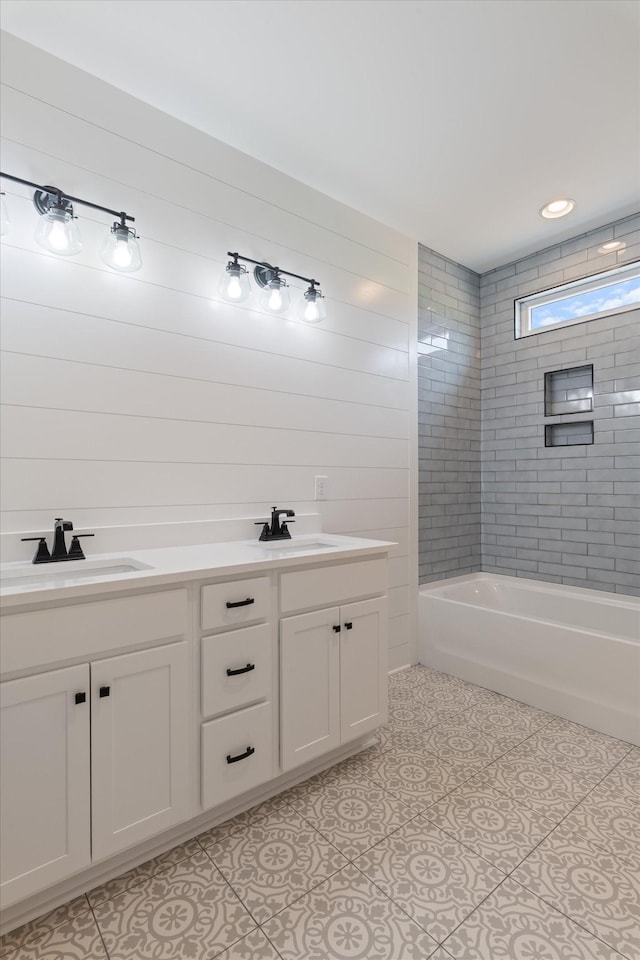 bathroom with double vanity, a sink, tile patterned flooring, and shower / washtub combination
