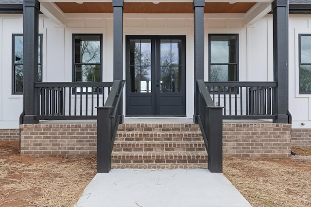 property entrance with a porch and french doors