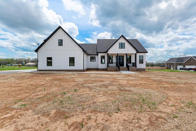 modern farmhouse featuring a porch and board and batten siding