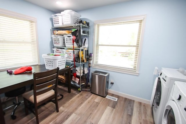 interior space featuring a wealth of natural light, light wood-style floors, laundry area, and washing machine and clothes dryer