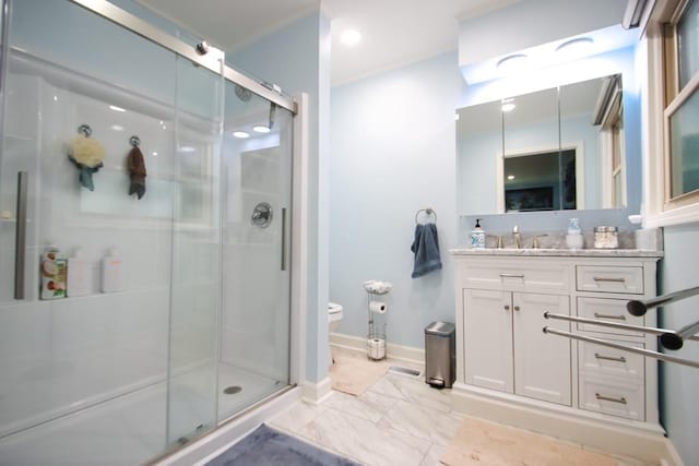bathroom with toilet, a stall shower, and vanity