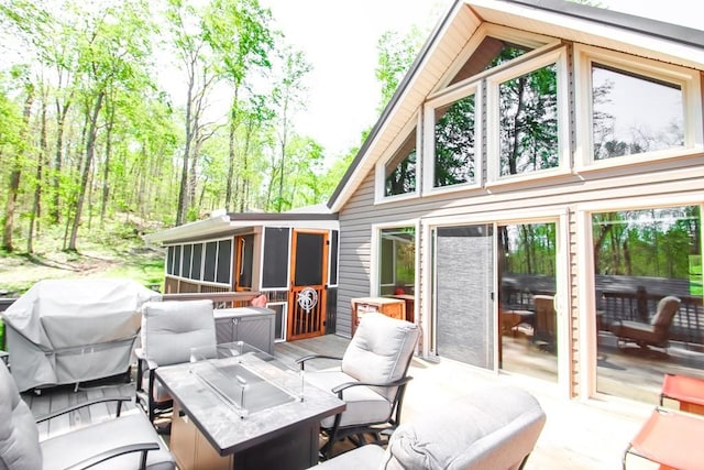 exterior space featuring grilling area and a sunroom