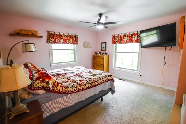 bedroom with baseboards, multiple windows, visible vents, and carpet floors