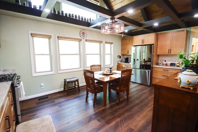 interior space featuring tasteful backsplash, baseboards, appliances with stainless steel finishes, and dark wood-type flooring