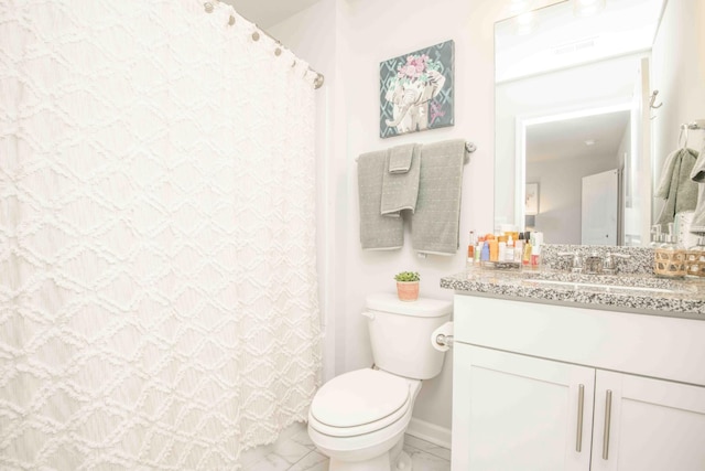 full bathroom with toilet, marble finish floor, and vanity